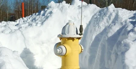 Fire hydrant in the snow with hydrant marker