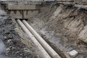 Service lines exposed in a trench in the ground