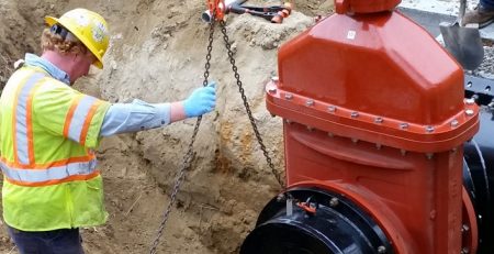 utility waterworks crew lifting a gate valve