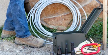 Service line puller kit components arranged at a worker's feet