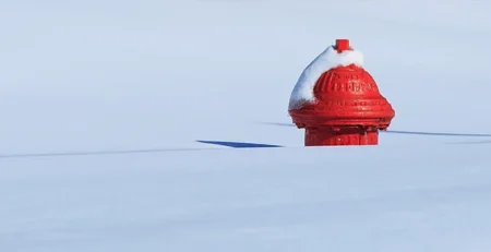 Top of red fire hydrant in deep snow