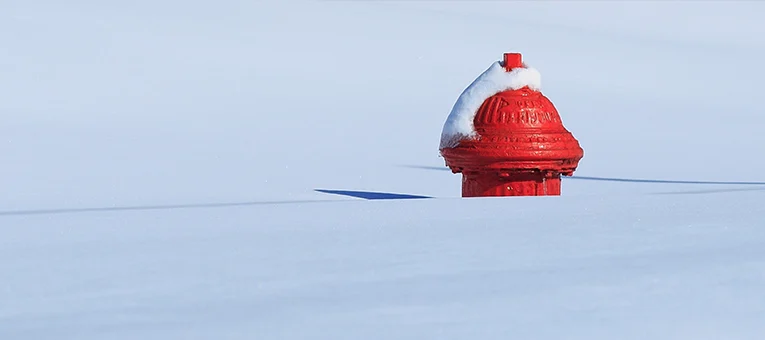 Top of red fire hydrant in deep snow