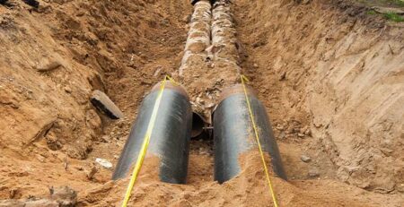 Pipes in a trench in the ground during service line replacement