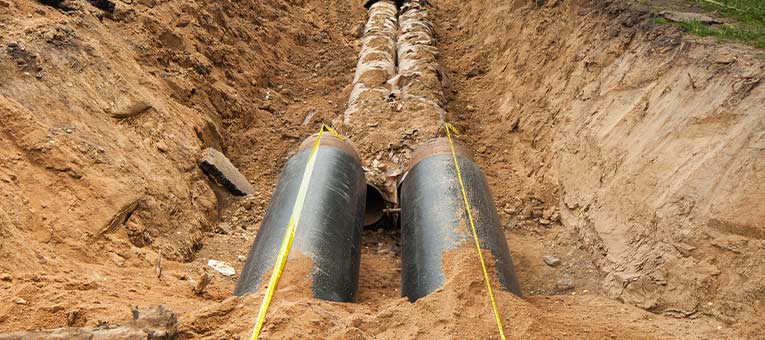 Pipes in a trench in the ground during service line replacement