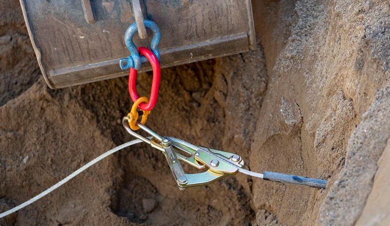 Service line puller kit in use drawing service line through the ground